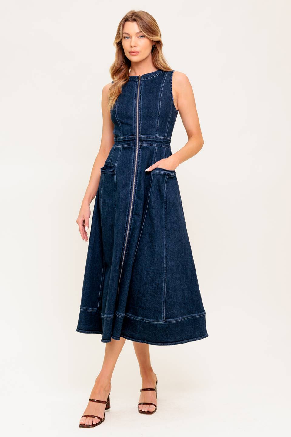 Woman wearing a blue denim dress on a white background