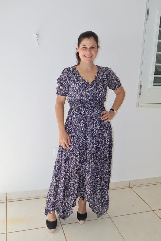 Navy floral maxi dress with a smocked stretch waistline and three-quarter sleeves, featuring a button-up front.