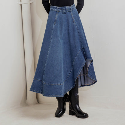 Woman wearing a black turtleneck and blue denim skirt against a white background