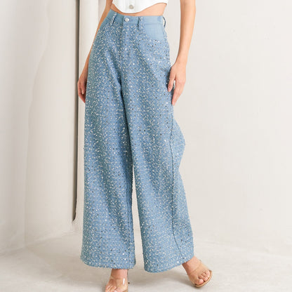 Light blue wide-leg denim jeans covered in silver sequins with high waist and five-pocket styling for festivals and parties