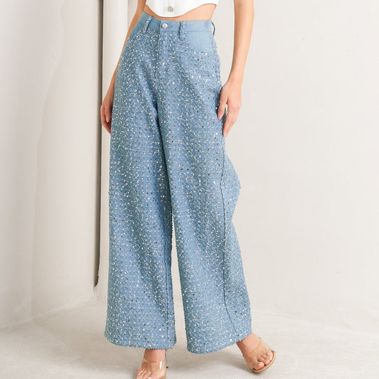Light blue wide-leg denim jeans covered in silver sequins with high waist and five-pocket styling for festivals and parties