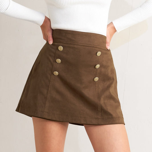 Brown skirt with button details worn by a person on a plain background