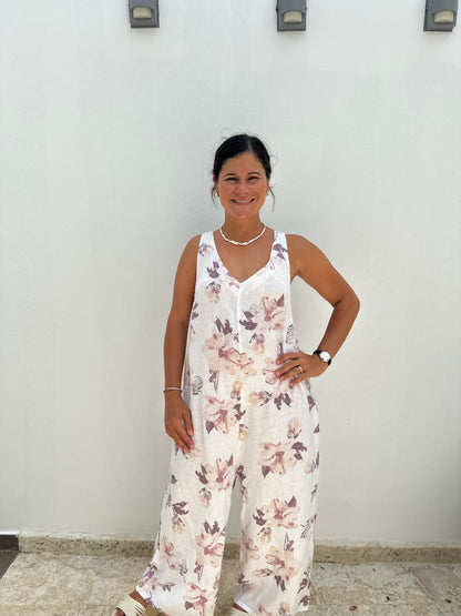 A women wearing a linen floral sleevles long jumpsuit