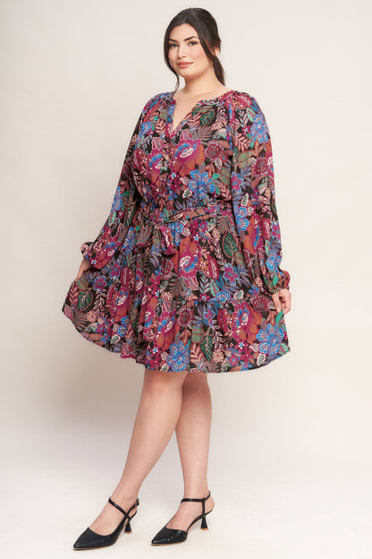 Plus Size Woman wearing a floral dress on a plain background