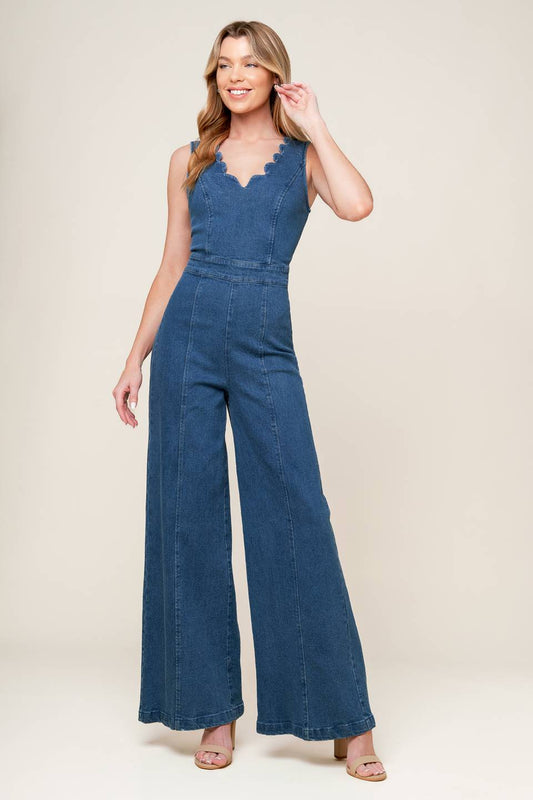 Woman wearing a blue jumpsuit on a beige background