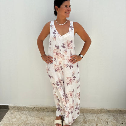 A women wearing a linen floral sleevles long jumpsuit