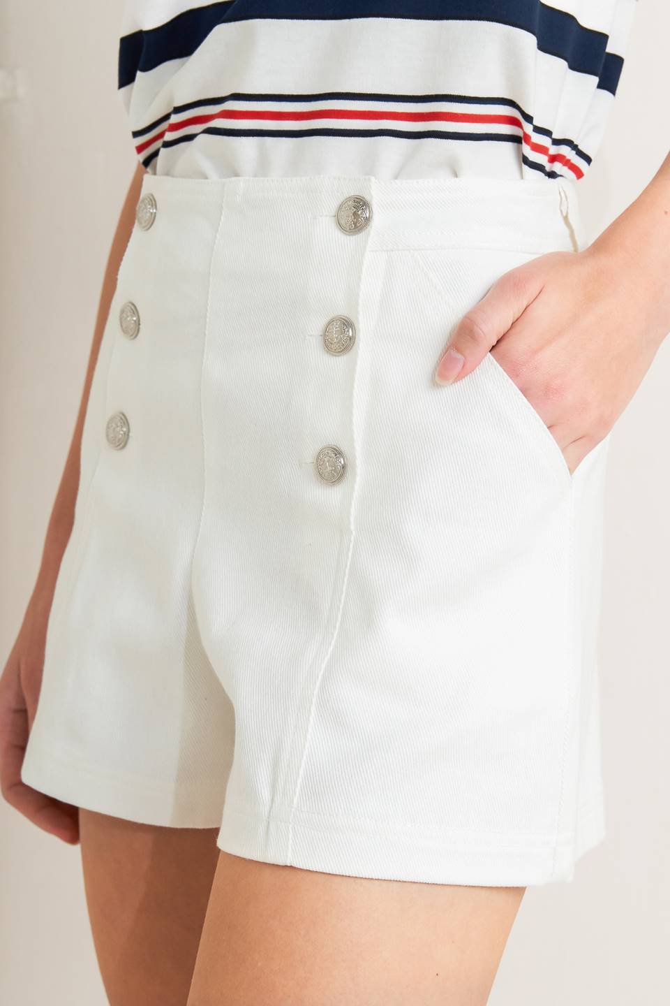 White high-waisted sailor shorts with silver anchor buttons and side pockets for nautical preppy style
These timeless shorts bring vintage maritime charm to modern wardrobes, offering a sophisticated piece that captures classic sailor style with polished tailoring and authentic nautical details perfect for coastal living and preppy fashion lovers.​​​​​​​​​​​​​​​​