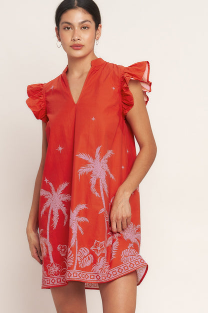 Woman wearing a Coral mini dress with pink palm tree embroidery, V-neck, and ruffle sleeves for beach vacation and tropical resort wear
This show-stopping dress brings instant vacation energy to your wardrobe, offering a bold statement piece that captures the carefree spirit of tropical destinations with vibrant color and playful embroidered details.​​​​​​​​​​​​​​​​
