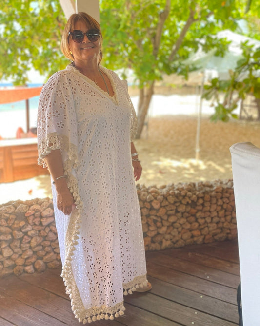 A women wearing a long cotton eyelet kaftan.