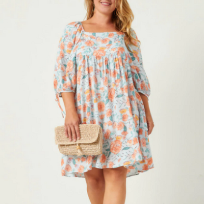 Plus size romantic floral mini dress with a square-cut neckline and puff sleeves. The dress features a multicolor floral pattern on a light background.